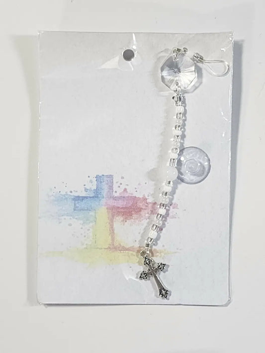 A small cross suncatcher featuring a clear faceted crystal charm with a silver-toned cross pendant and white beads