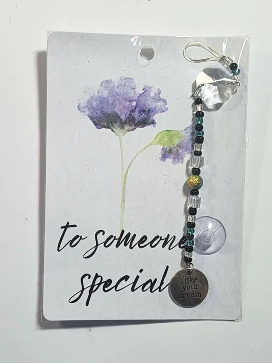 Small special suncatcher featuring a silver-toned live your dream charm on a beaded chain ideal for direct sunlight
