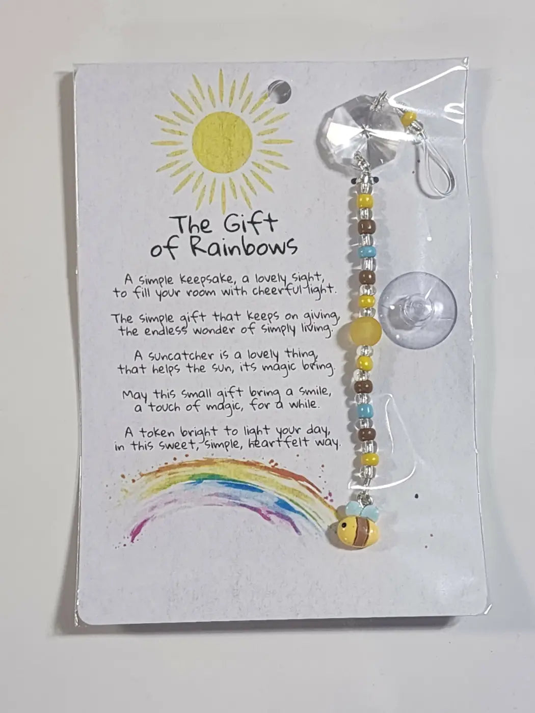 Small suncatcher handmade with yellow and brown beads and a clear crystal top featuring blue green and gold accents for natural skincare canada