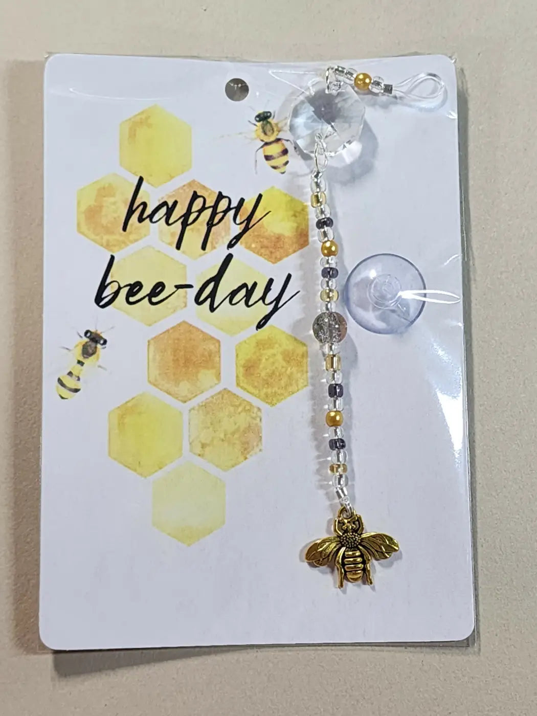 Small suncatcher featuring a gold bee charm with clear crystal and metallic beads on a beaded chain for natural skincare canada gifts