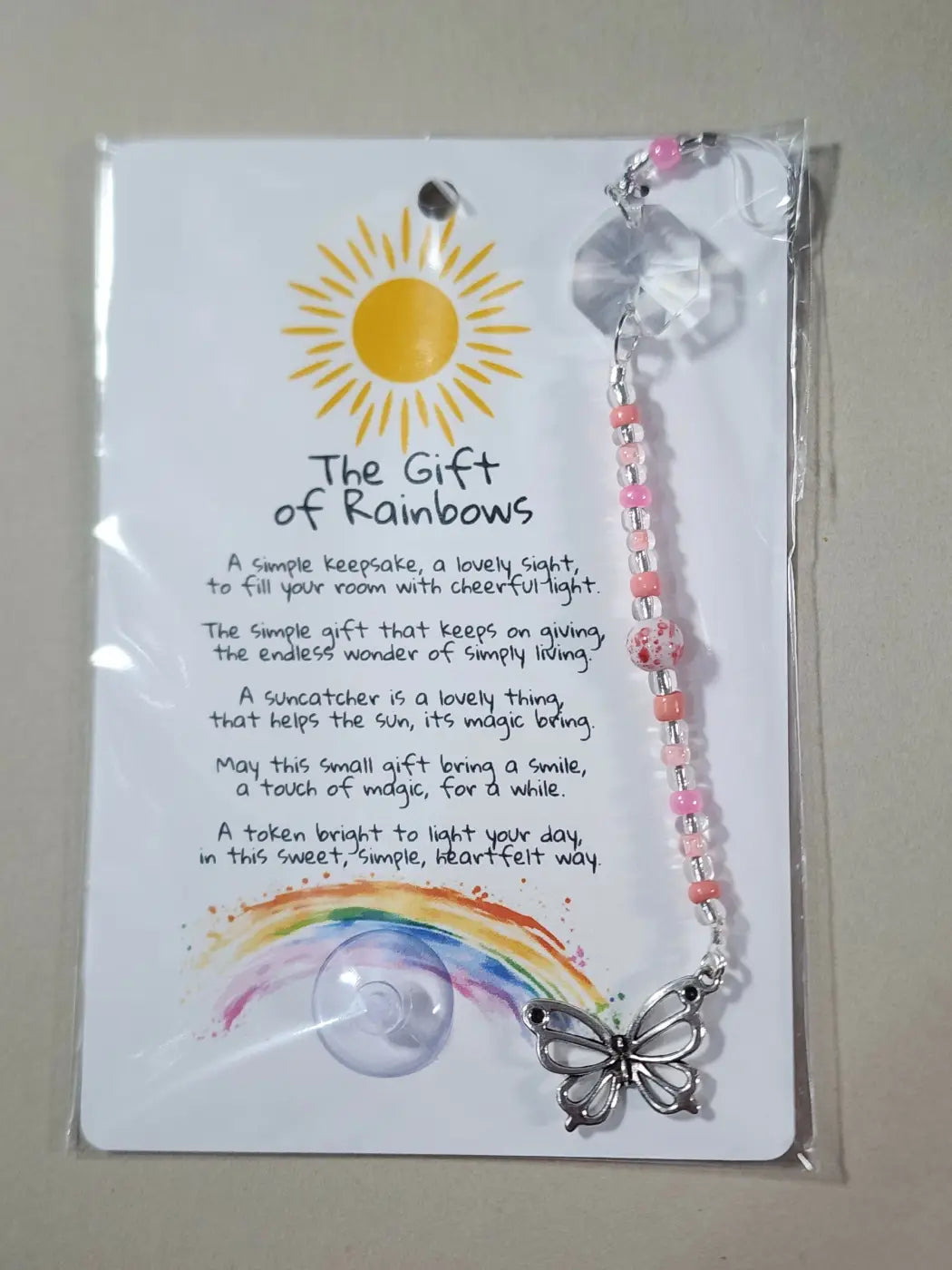 Small suncatcher featuring a delicate silver butterfly with pink and peach beads and a clear crystal charm, perfect for canadian made skincare spaces