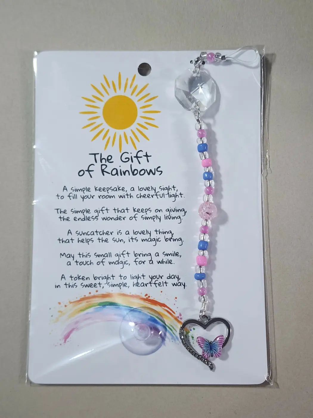 Small suncatcher heart shaped with butterfly charm featuring pink and blue beads on clear crystal links canadian made skincare