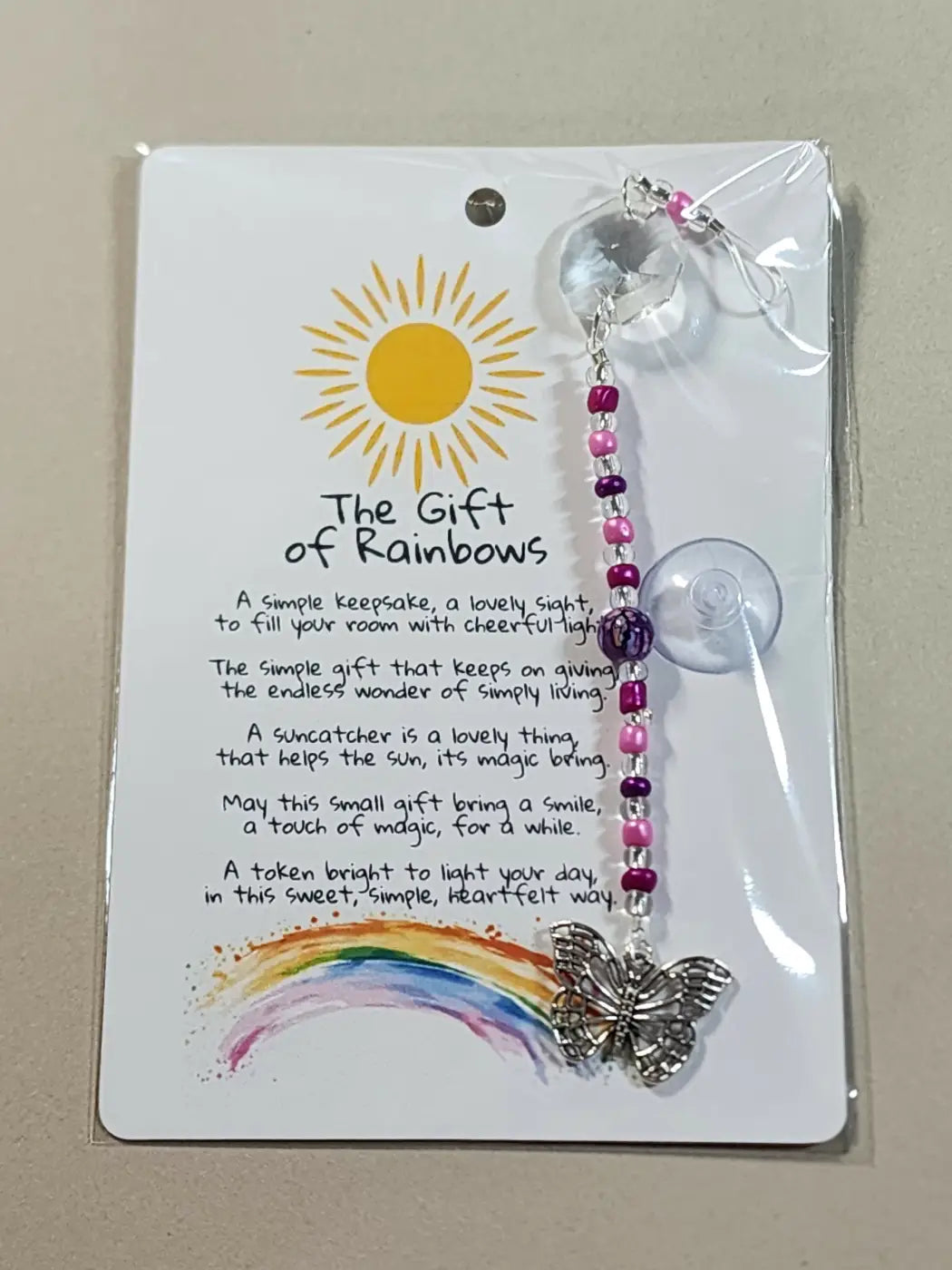 Small suncatcher silver butterfly with pink purple beads and clear crystal sphere reflecting canadian made skincare style