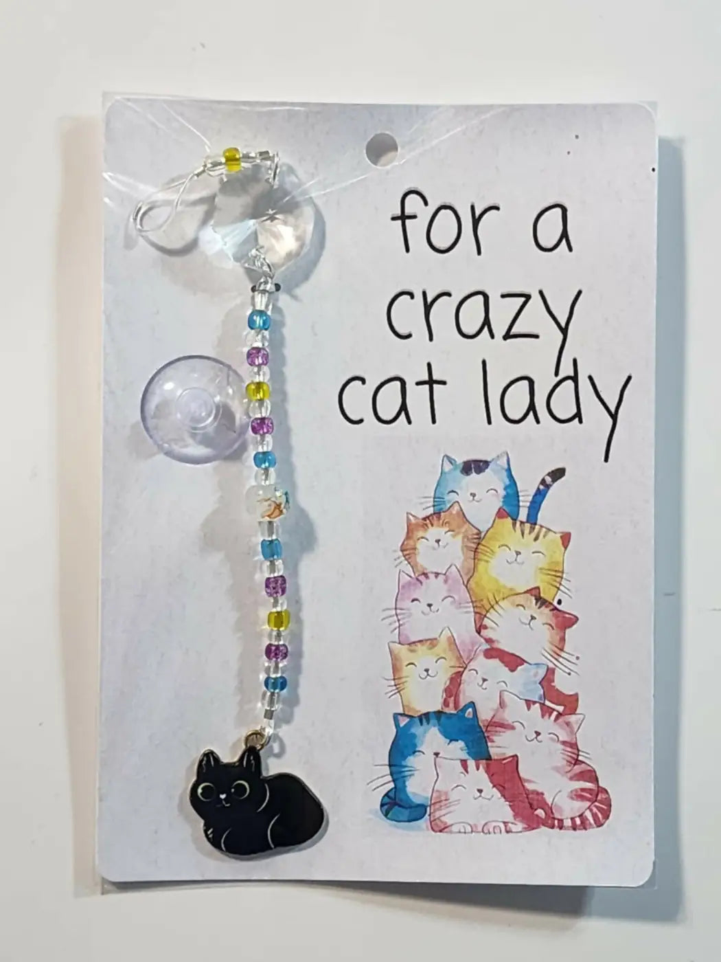 Small suncatcher featuring a handmade black cat charm with colorful beads and crystal pendant for natural skincare canada