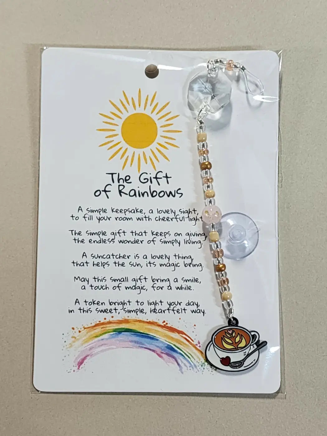 Small suncatcher with a clear faceted crystal, multicolored bead string, and coffee cup charm for canadian made skincare decor