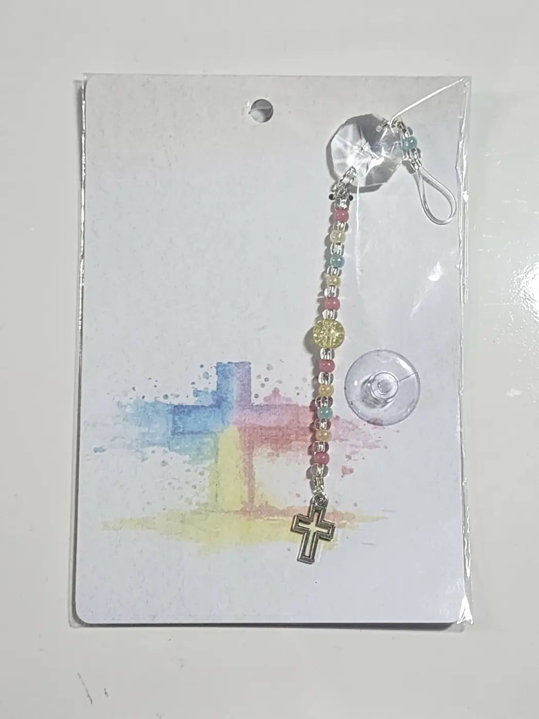 Small suncatcher featuring a colorful handmade beaded rosary charm with a silver cross and clear crystal accents for natural skincare Canada gift