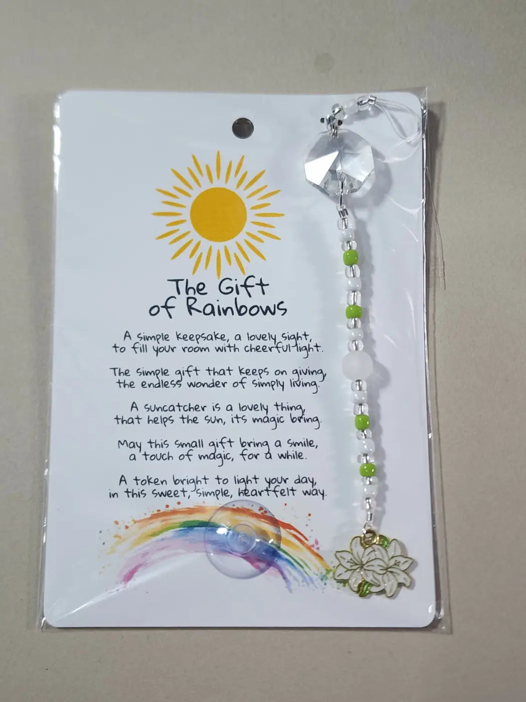 Small suncatcher with clear faceted crystal top, green and white beads, and gold-toned flower charm, ideal for canadian made skincare decor