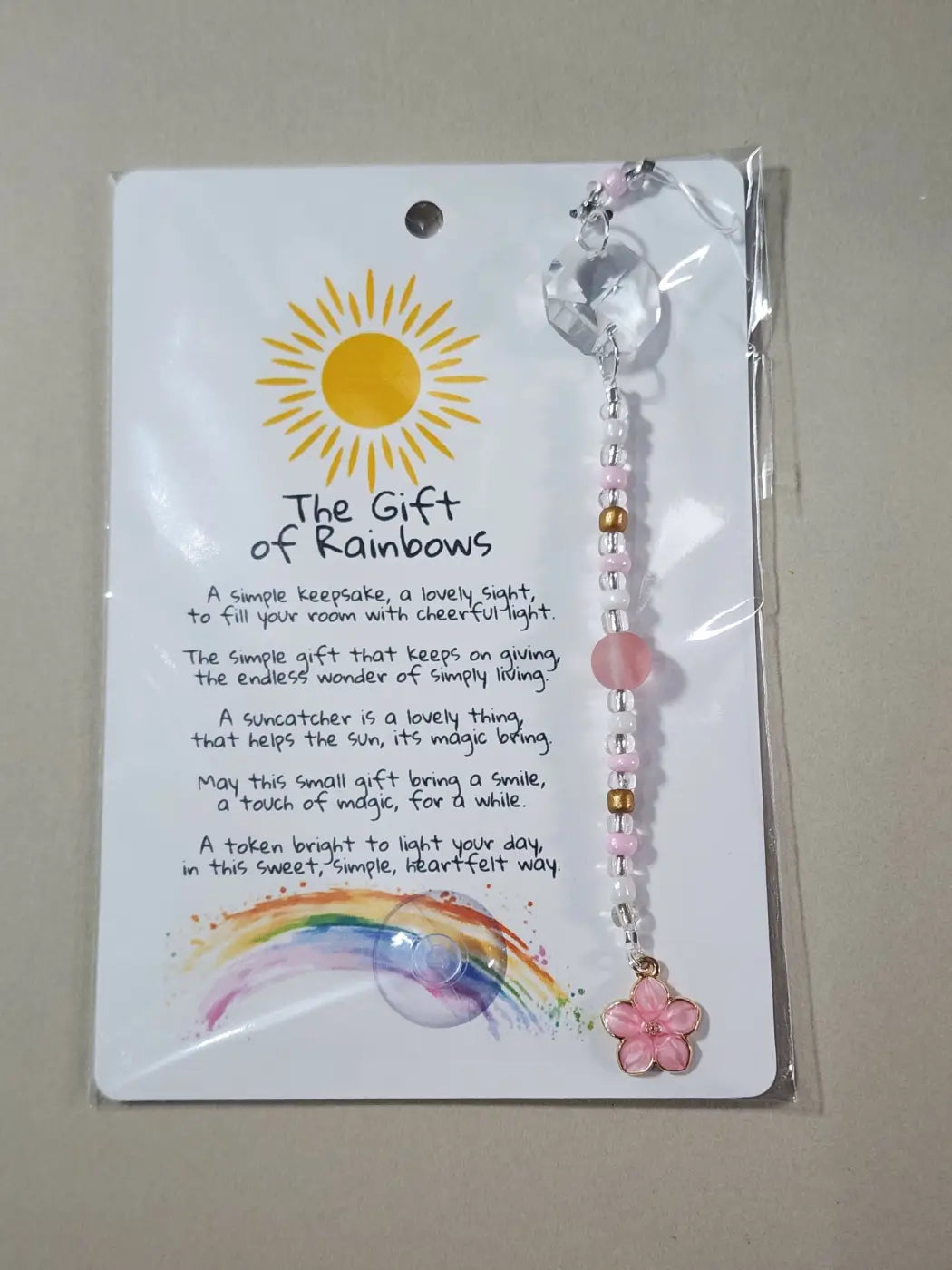Small suncatcher featuring a pink cherry blossom shape with clear crystal top and pink white gold beads, canadian made skincare accessory