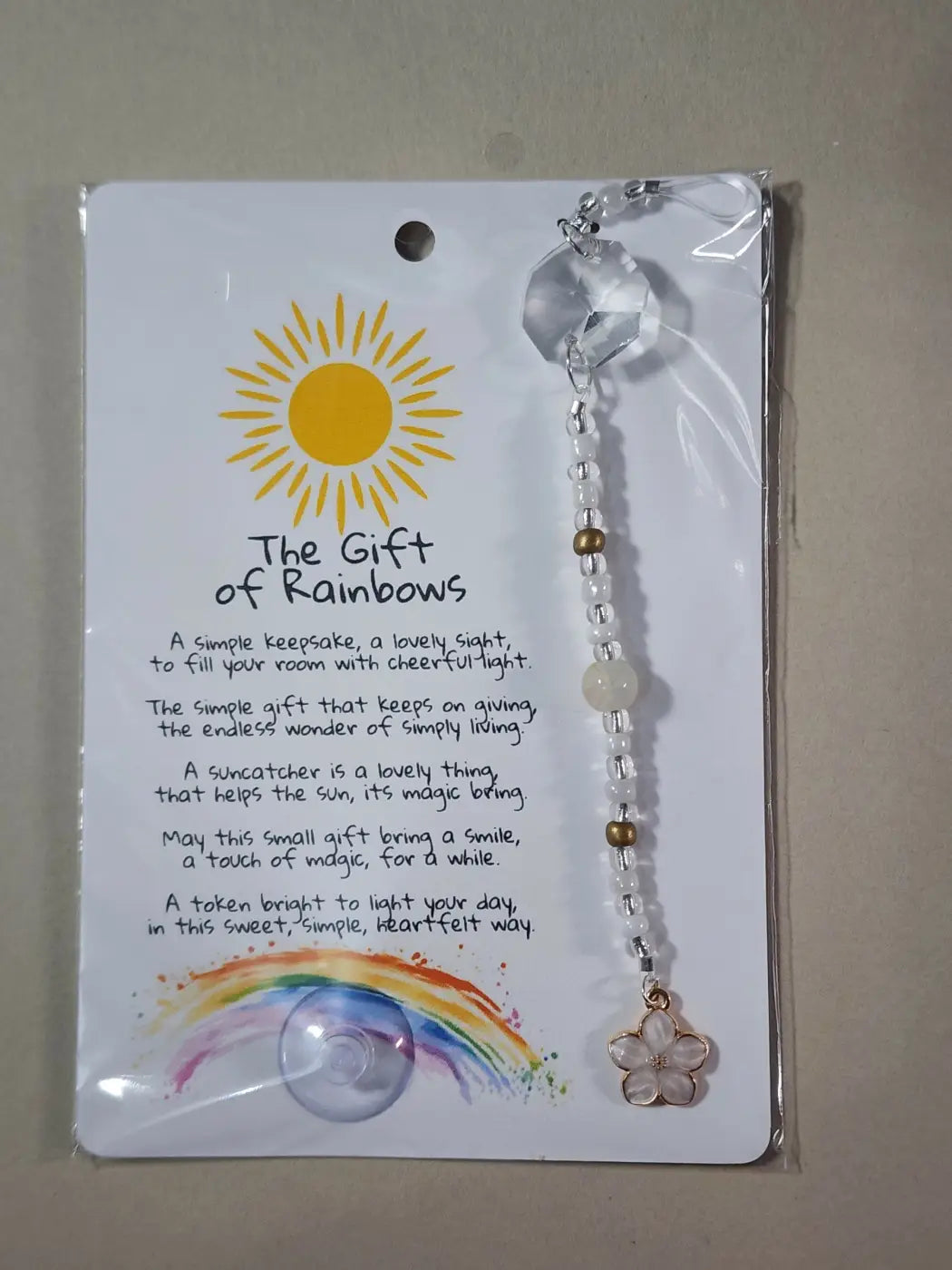 Small suncatcher with clear faceted crystal and white gold bead chain ending in pink flower charm for canadian made skincare decor