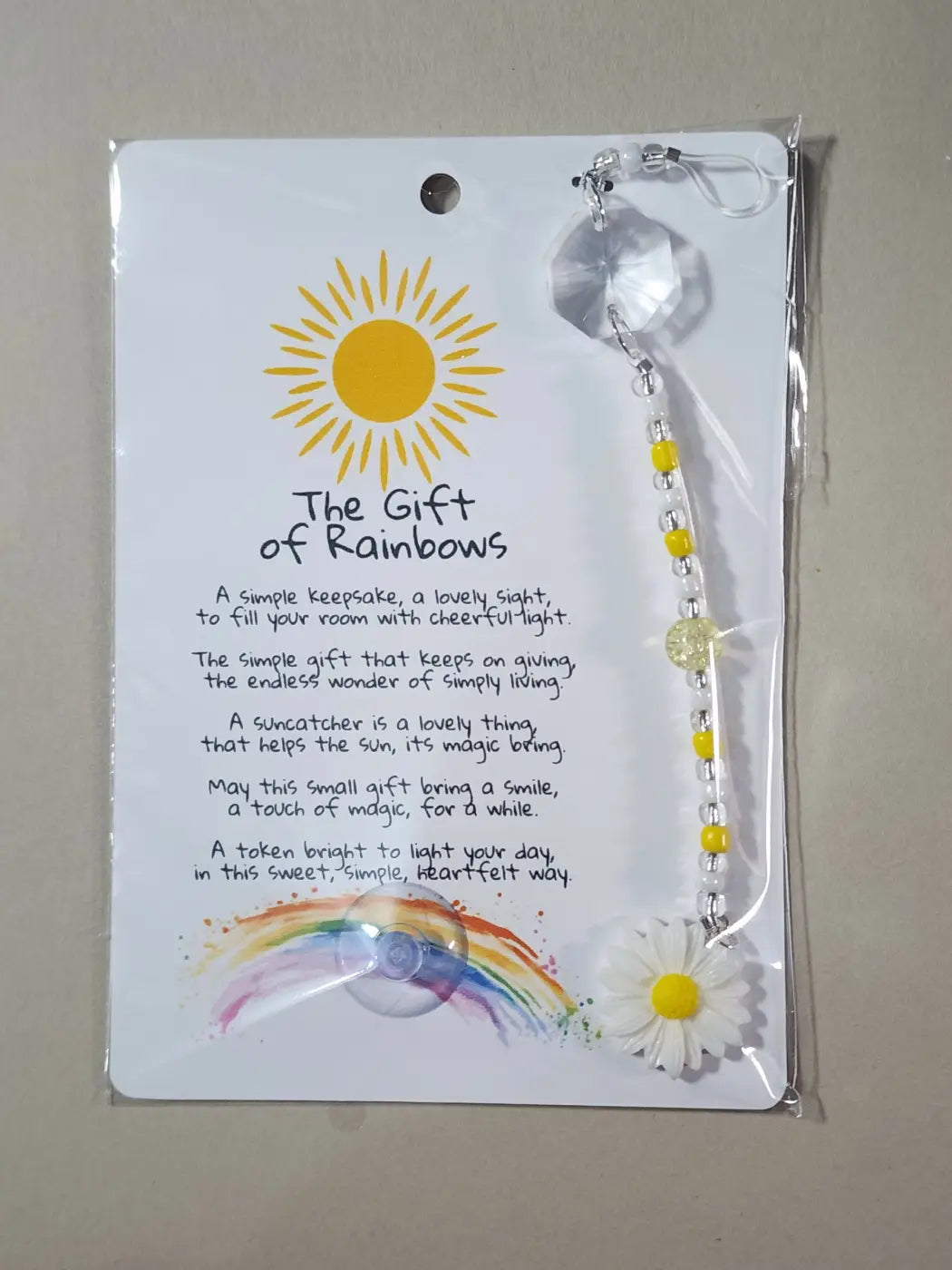 Small suncatcher with clear faceted crystal top yellow silver beads and white daisy highlights canadian made skincare