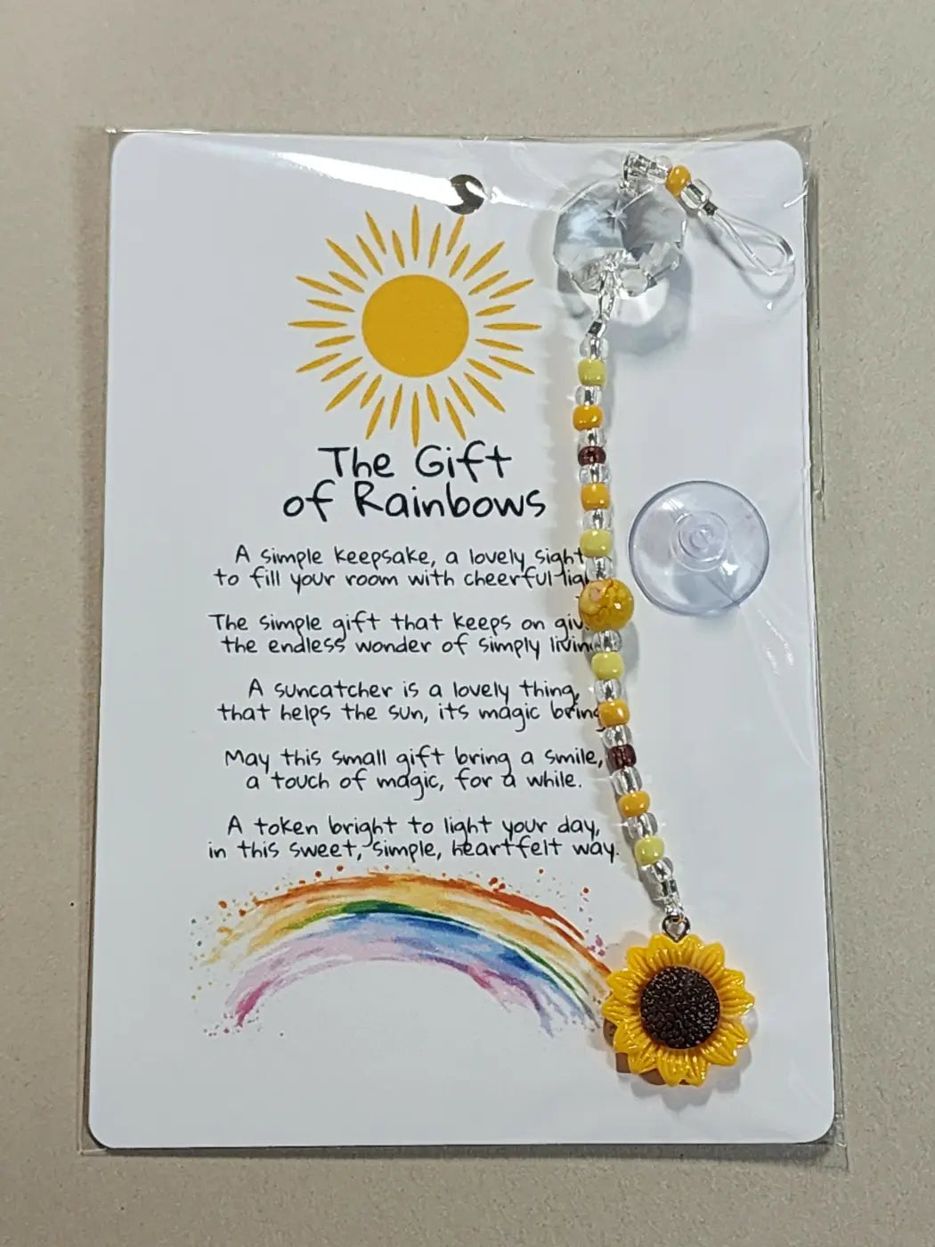 Small suncatcher yellow sunflower shaped with clear crystal top and beaded chain on the gift of rainbows card Canadian made skincare