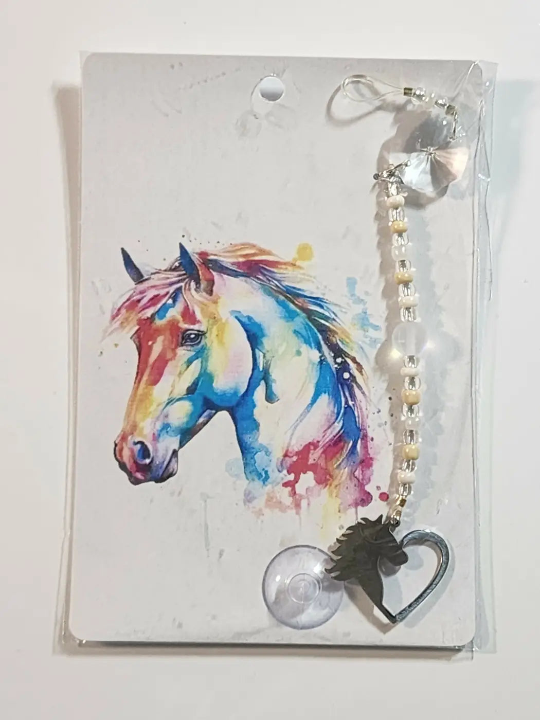 Small suncatcher with colorful watercolor-style horse head charm, beaded chain, crystal accents, and heart-shaped metal clasp