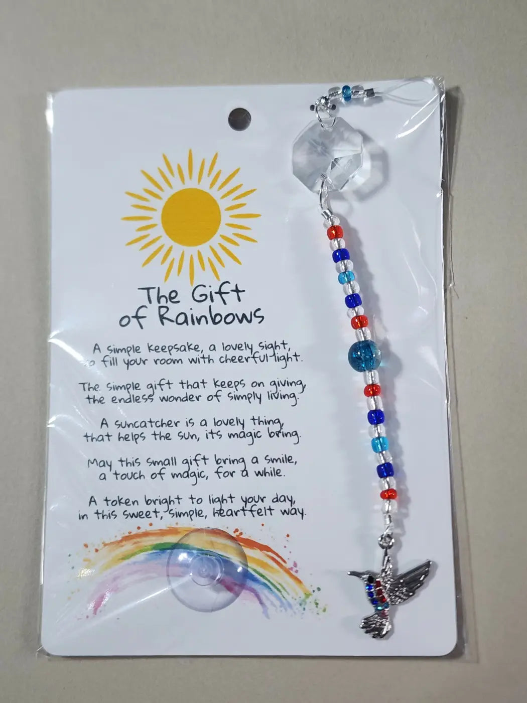 Small suncatcher with clear faceted crystal, red white and blue glass beads, and a silver hummingbird charm for natural skincare canada