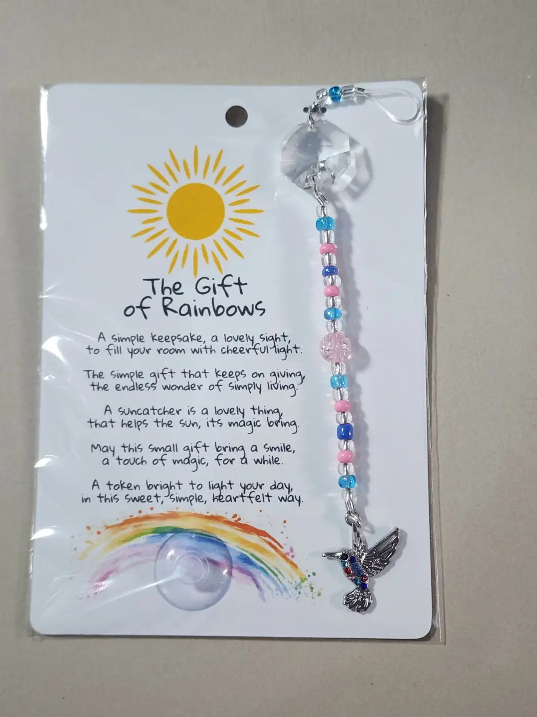 Small suncatcher with clear faceted crystal, hummingbird charm, and colorful beaded chain for natural skincare Canada decor