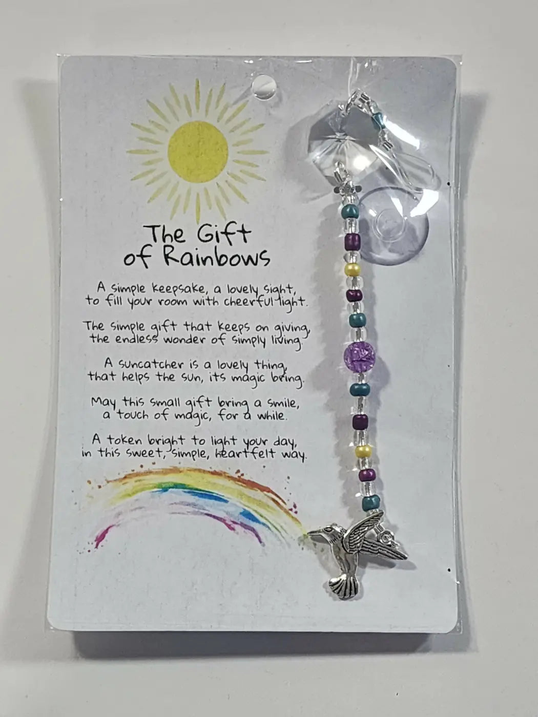 Small suncatcher silver hummingbird with clear crystal top and colorful beaded chain inspired by canadian made skincare