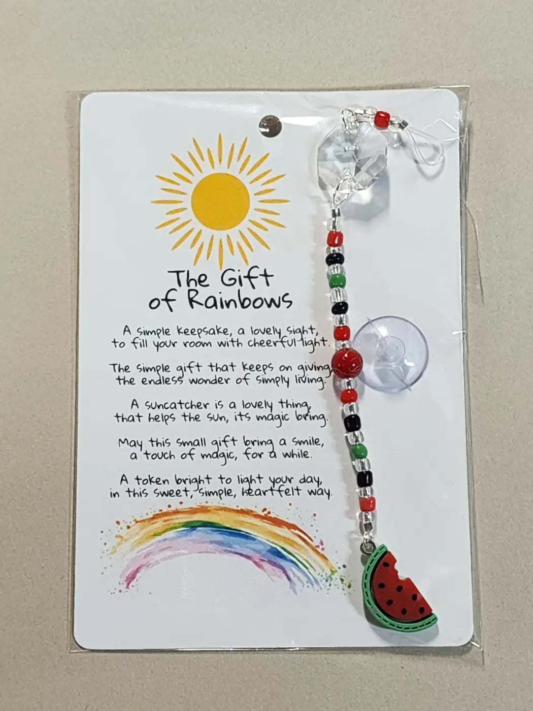 Small suncatcher featuring a red and black beaded design with a watermelon slice charm promoting canadian made skincare gifts