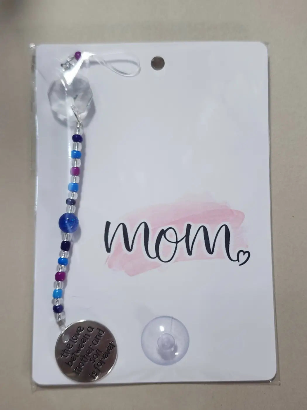 Small suncatcher with a clear crystal bead and blue purple white beads featuring a silver-toned clasp, ideal for canadian made skincare spaces