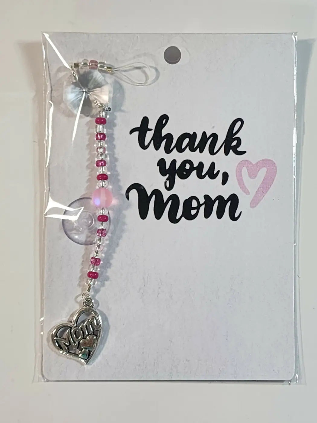 Small suncatcher silver heart charm with engraved text on pink and clear beaded chain, ideal for natural skincare Canada gifts