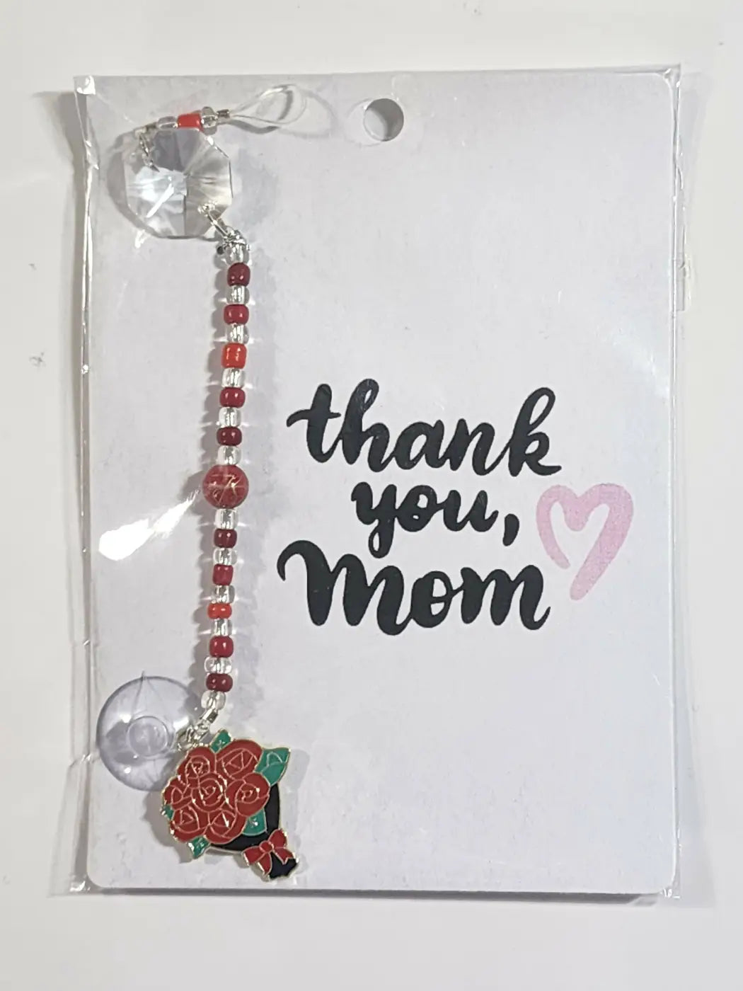 Small suncatcher featuring a red and green rose bouquet charm with silver beads and clear crystal accents, ideal for canadian made skincare gift sets