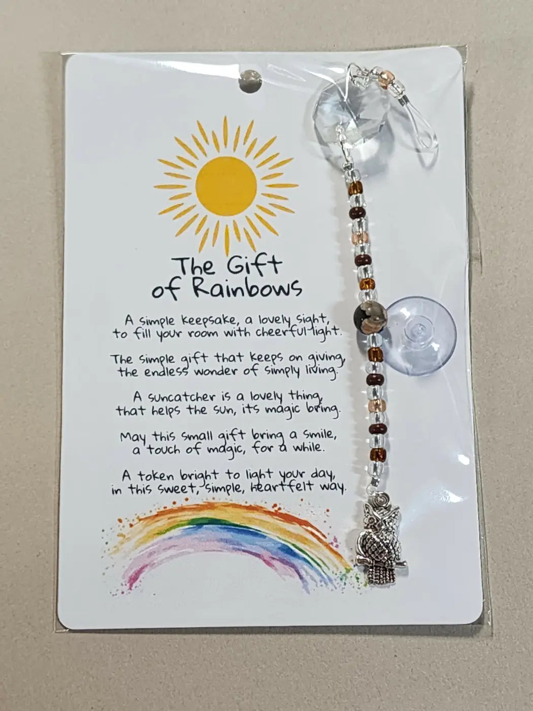 Small suncatcher silver owl shaped with clear crystal top and brown amber beads ideal for canadian made skincare spaces