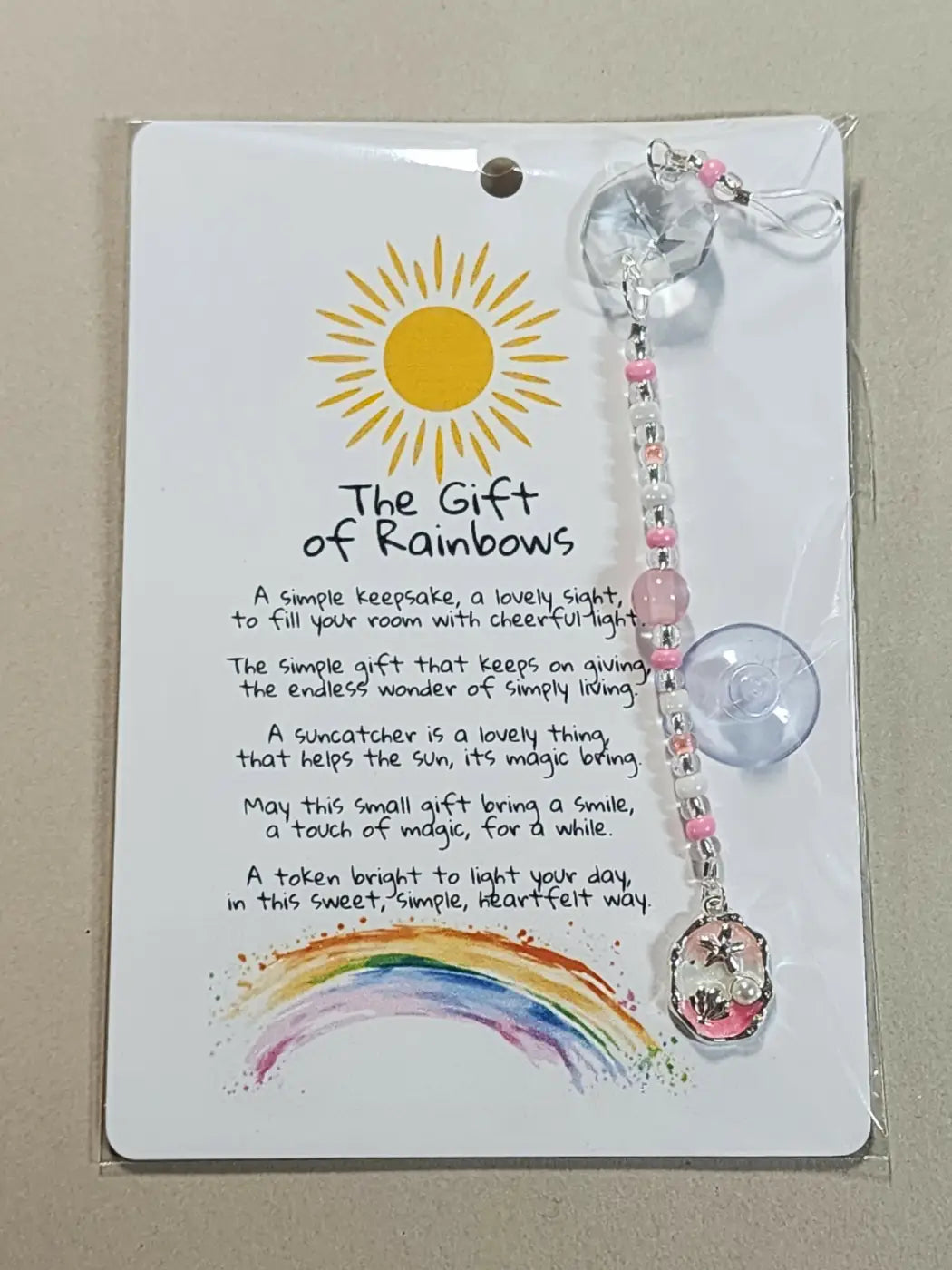 Small suncatcher with pink and clear beads, crystal charm, star pendant, and suction cup for direct sunlight display