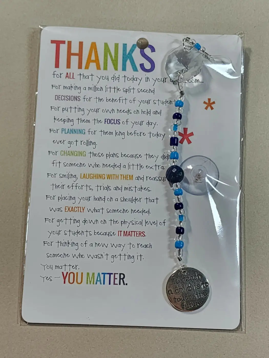 Small suncatcher beaded carabiner charm with blue beads and silver pendant engraved to teach a child is to touch the future, ideal for canadian made skincare gifts