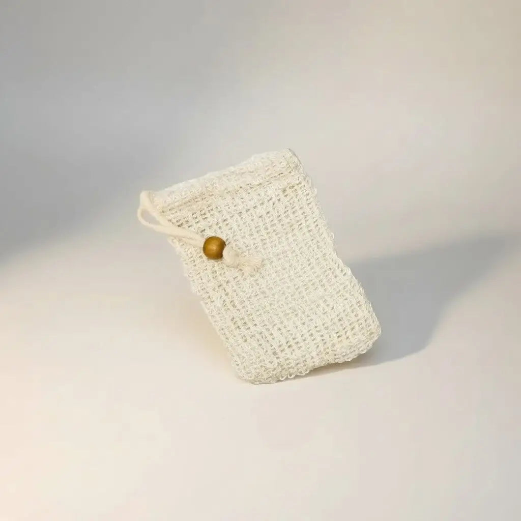 White woven mesh soap saver bags with drawstring closure and wooden bead for gentle exfoliation and luxurious lather