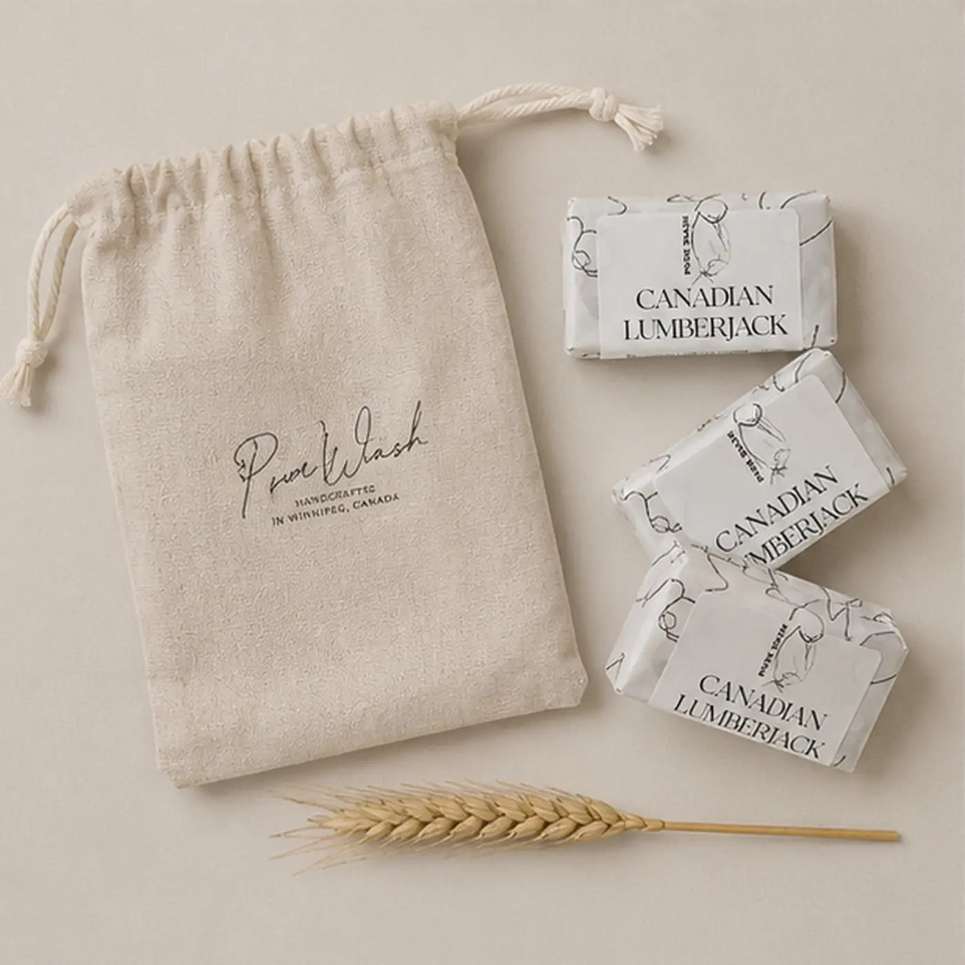 Beige linen canvas drawstring bag with purewash branding and natural fiber tie for soap trio and botanical soap bars