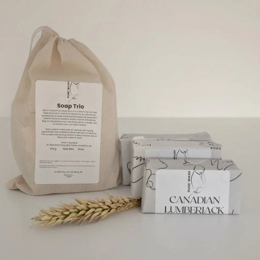 A white botanical soap bar with black line art labeled canadian lumberjack included in soap trio with cotton canvas drawstring bag