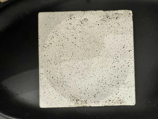 Square soap dish made of white concrete tile with black speckles suitable for use with penetrating sealer and pure wash
