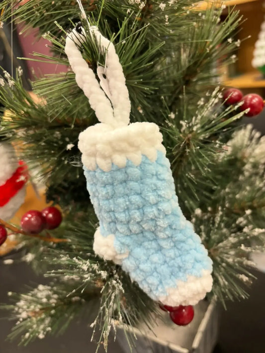 A hand-crocheted light blue and white stocking ornament with a textured fuzzy finish for natural skincare Canada