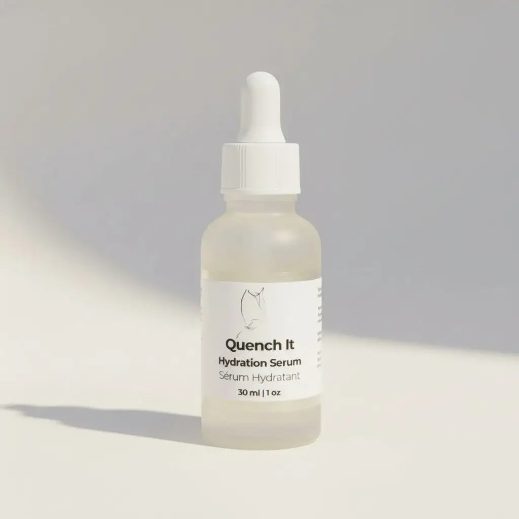 A clear glass bottle with white dropper cap containing quench it hydration serum from the it line skincare bundle