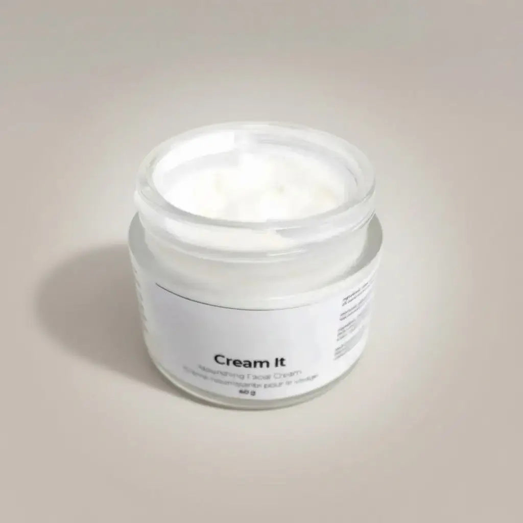 A minimalist white glass jar with creamy face cream labeled cream it from the it line skincare complete bundle