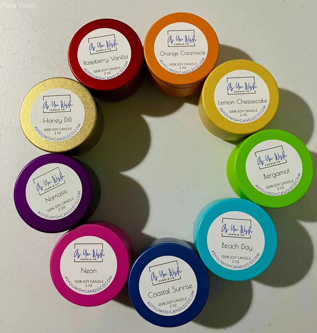 A collection of colorful round soy candles in vibrant hues from the rainbow candle collection including a blue tin candle