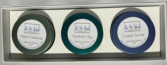 The wander soy candle collection features three 2 oz soy candles in alpine getaway, northern sky, and coastal sunrise colors