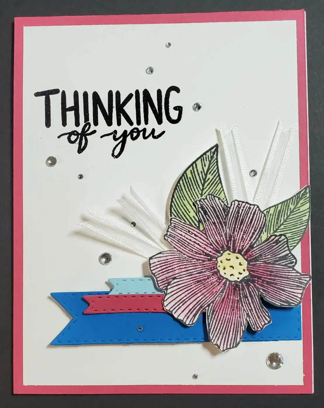 Thinking of you 3 card with a pink flower yellow center and green leaves on blue and red ribbons for standard cards
