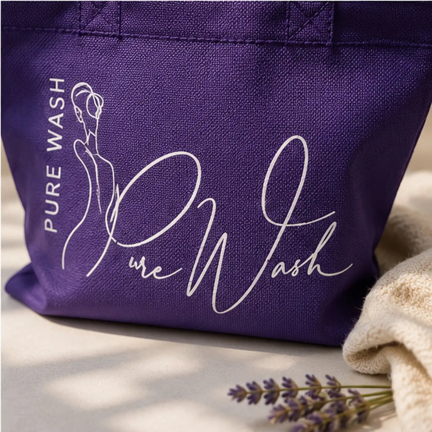 Purple canvas reusable tote bag with white line-art woman silhouette and pure wash logo for handcrafted soap bars bundle