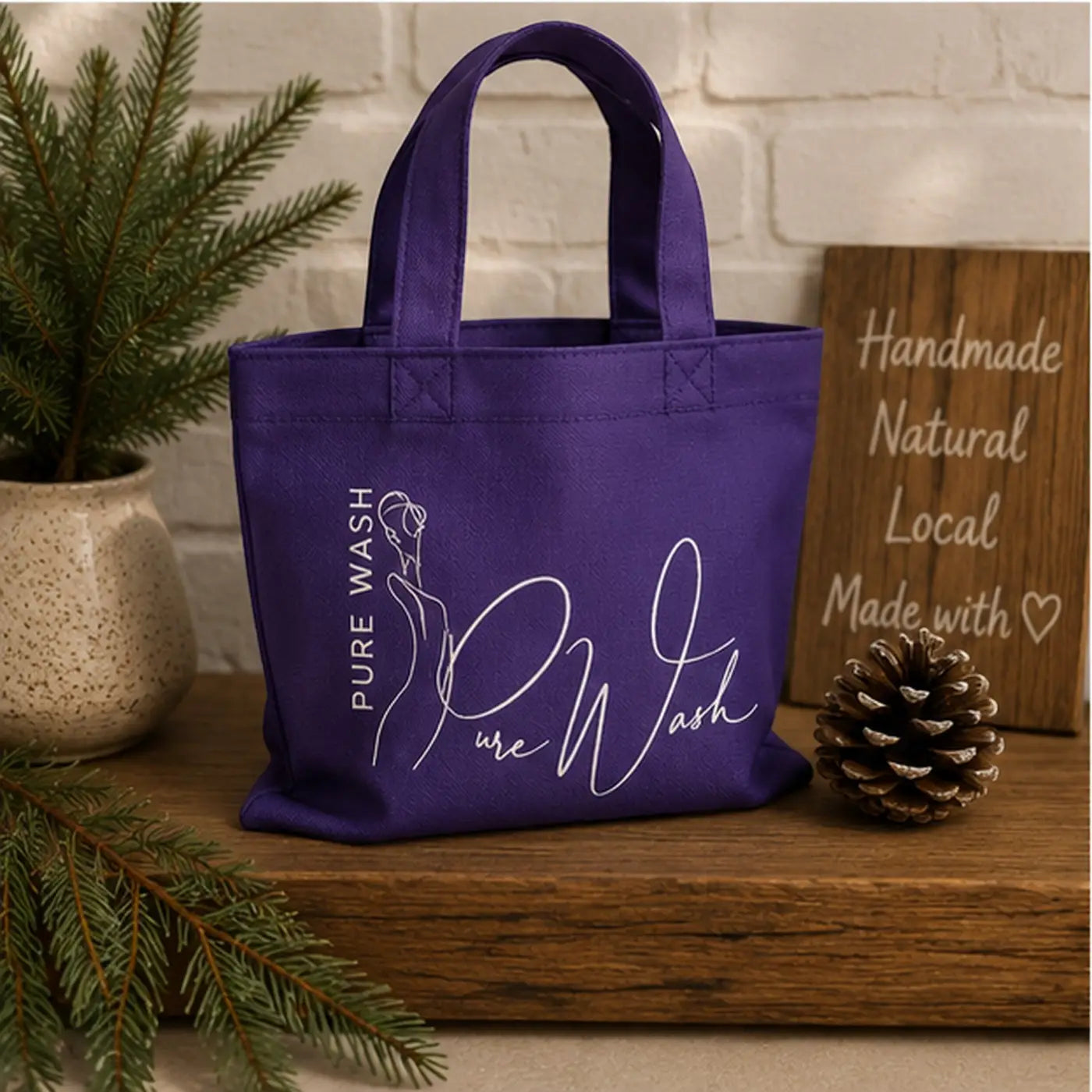 Purple reusable tote bag with white pure wash logo and woman silhouette designed for handcrafted soap bars bundle