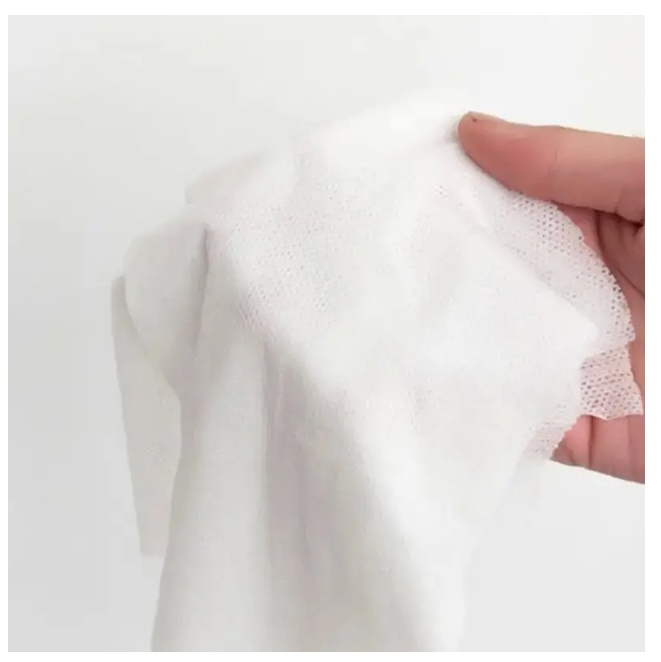 Compressed biodegradable face towel in hand, eco-friendly and convenient for travel use.
