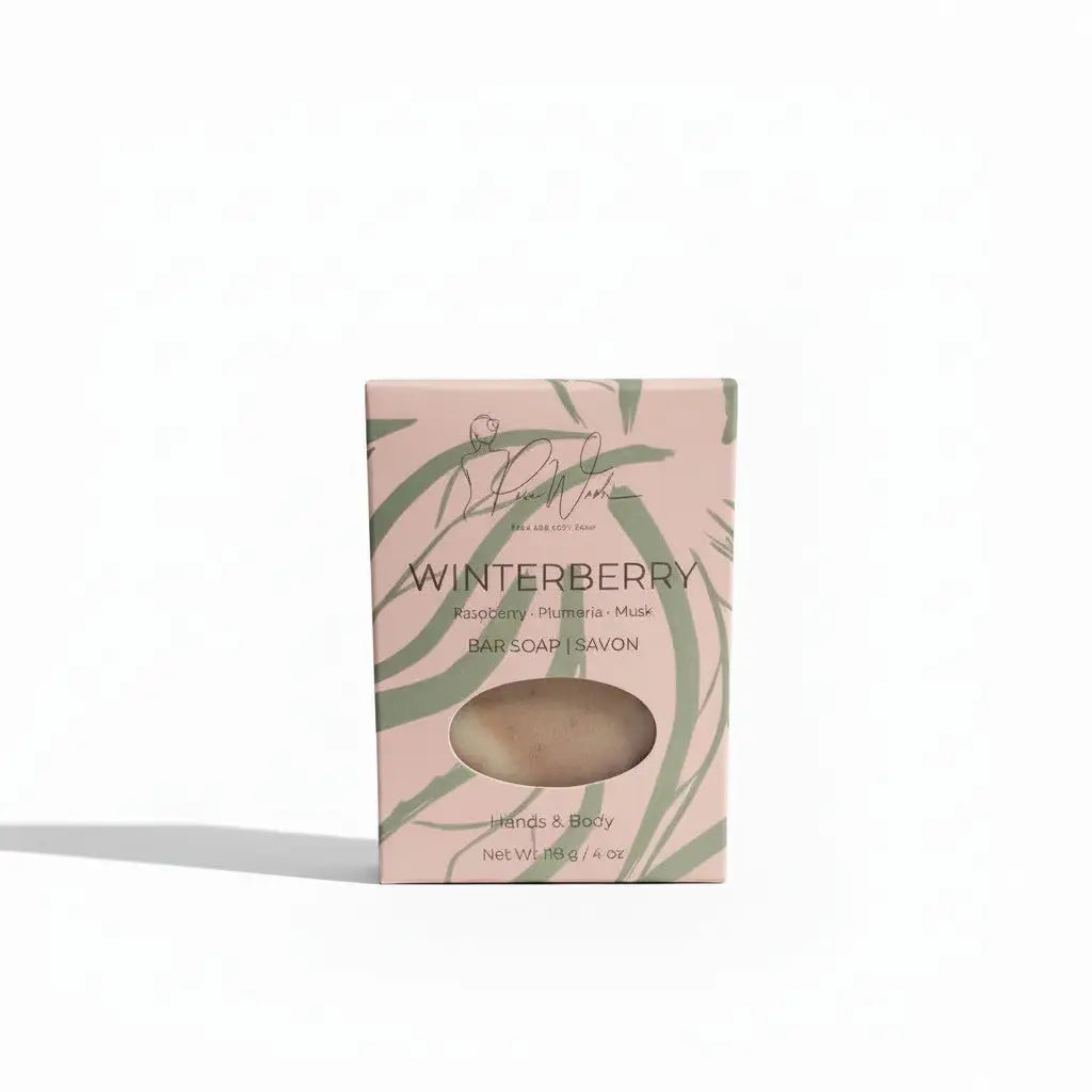 A pale pink winterberry soap bar box with green leafy patterns displaying a light beige handmade soap supporting healthy skin