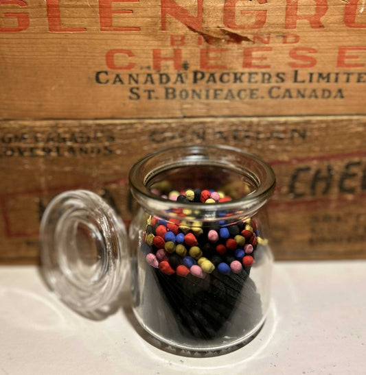 Vintage Glass Jar with LidMatch VesselVintage Glass Jar repurposed into a match vessel! Use the lid as a place to put your spent matches. Filled with multicolored tipped matches with black stained wood mVintage Glass JarCG Pure Wash