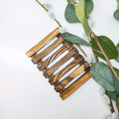 Wooden soap saver tray with slatted design to enhance soap longevity.