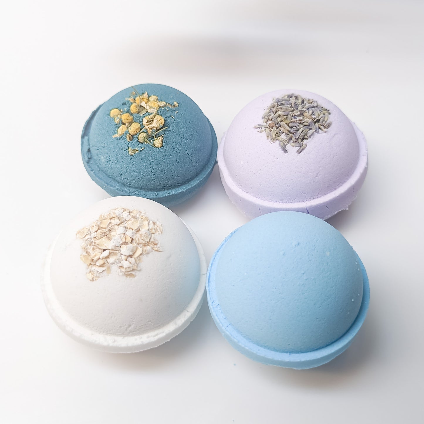 Fizzing Blue Chamomile Bath Bomb, releasing the moisturizing properties of cocoa butter and avocado oil for ultimate skin nourishment | CG Pure Wash.