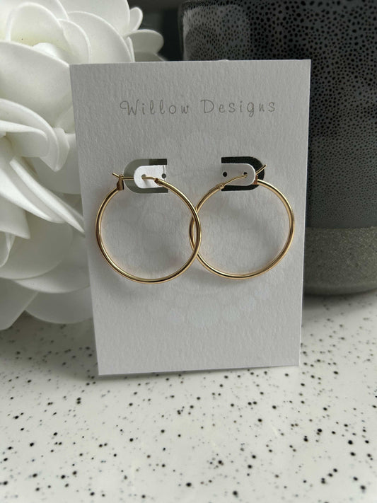 35mm Gold Hoop EarringsThese pretty hoops are 14K gold plated. They are hypoallergenic and nickel free.35mm35mm Gold Hoop EarringsCG Pure Wash