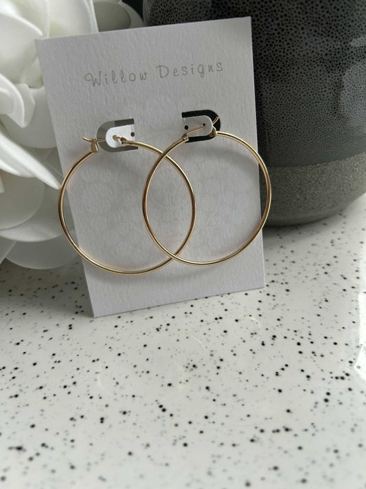 45mm Gold Hoop EarringsThese pretty hoops are 14K gold plated. They are hypoallergenic and nickel free.45mm45mm Gold Hoop EarringsCG Pure Wash