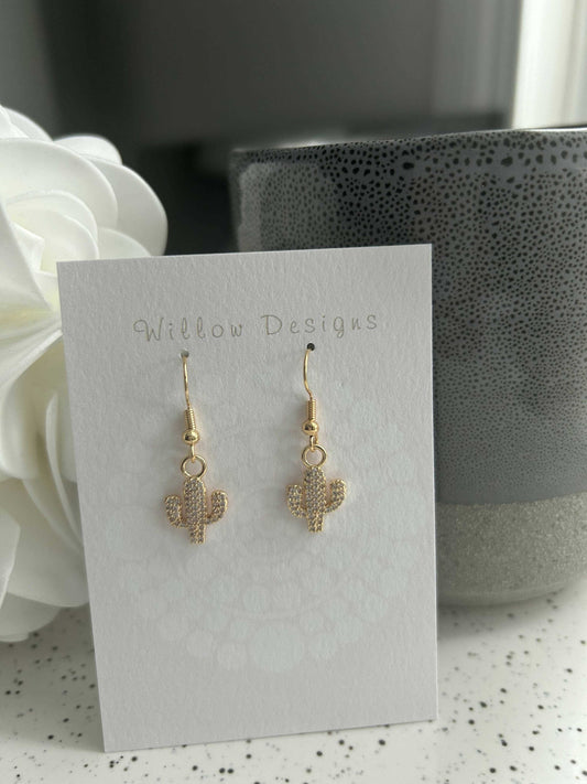 Gold Cactus Dangly EarringsJewelryThese cactus earrings are just the cutest!-14K gold plated-hypoallergenic -nickel freeGold Cactus Dangly EarringsCG Pure Wash