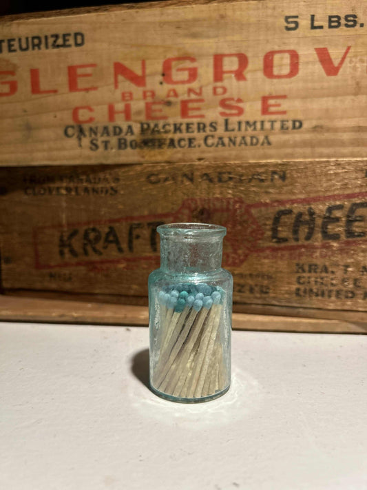 Small Antique Aqua BottleMatch VesselSmall Antique Aqua Bottle mudlarked from one of the rivers in Manitoba, now repurposed as a match vessel! Filled with colored matches made of aspen wood, hand crafteSmall Antique Aqua BottleCG Pure Wash